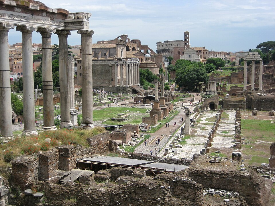 The Roman Forum today: ruins of columns, arches, and temple foundations among the cypress trees on the floor of central Rome