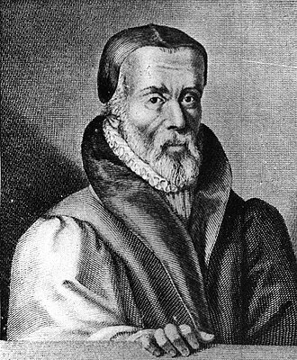 A 16th-century oil portrait of William Tyndale, shown from the chest up wearing dark scholar&rsquo;s robes and a flat black cap, looking directly at the viewer with a steady gaze. An inscription in the upper background identifies him.